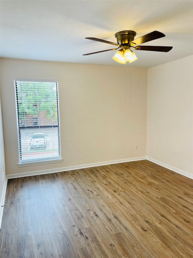 Primary Bedroom featuring wood finished floors and ceiling fan