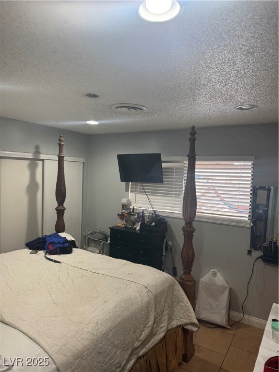 Bedroom featuring baseboards, tile patterned floor