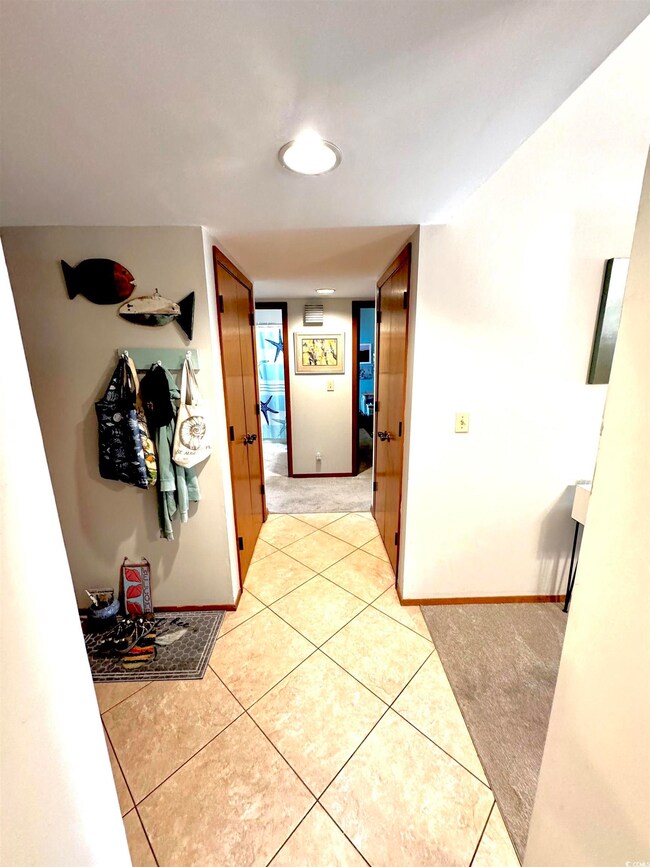 Hall featuring light tile patterned flooring