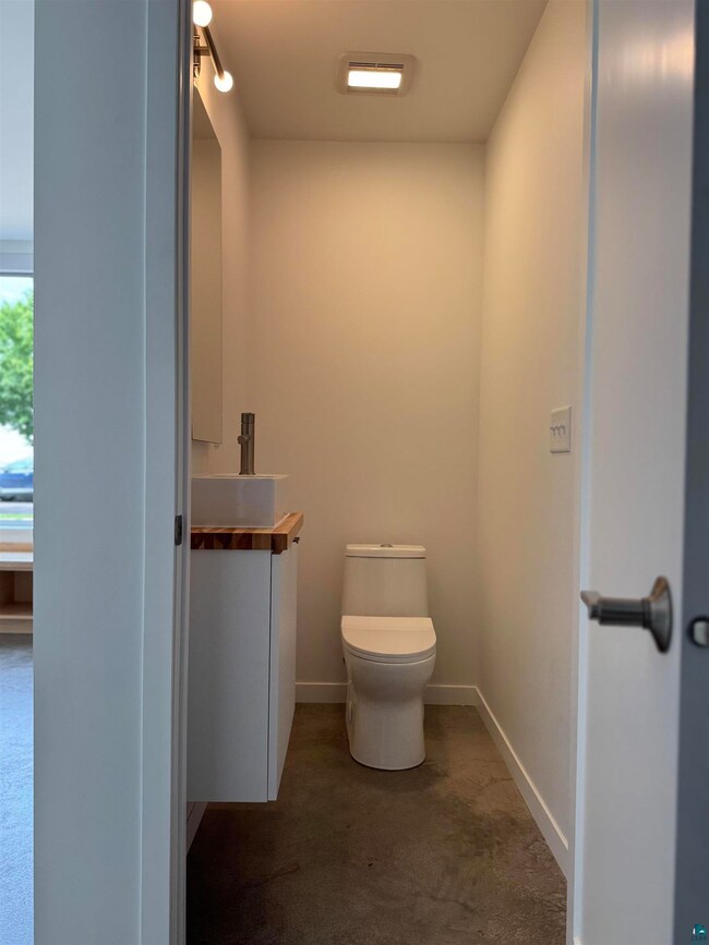 Half bath featuring vanity and toilet