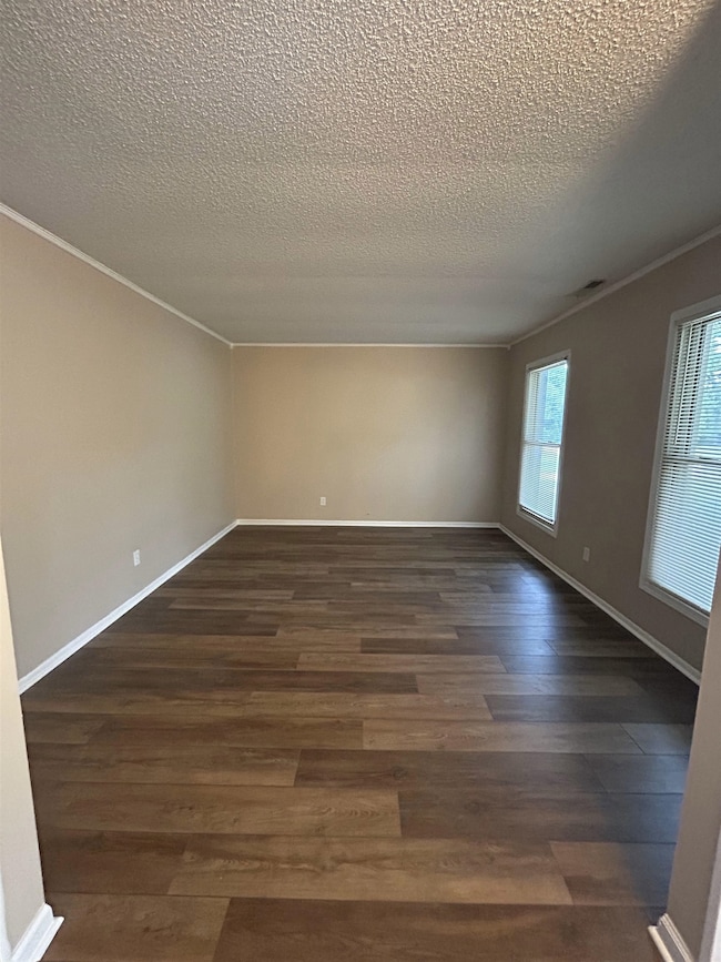 Unfurnished room with ornamental molding, a textur