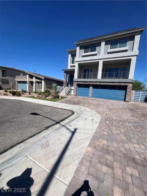 View of front of home featuring a garage, decorati