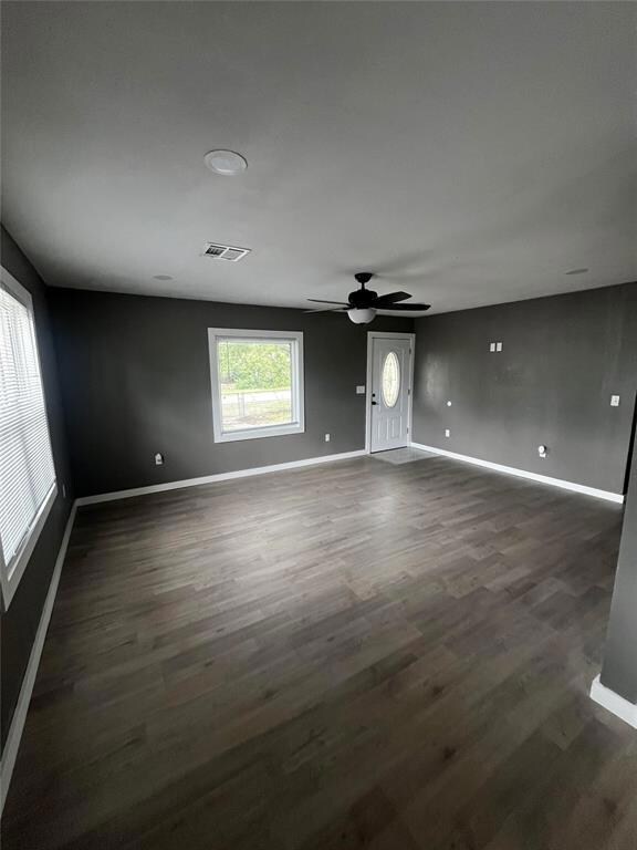 Living room featuring ceiling fan and light hardwo