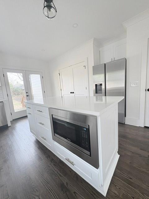 Kitchen featuring white cabinetry, dark wood-style