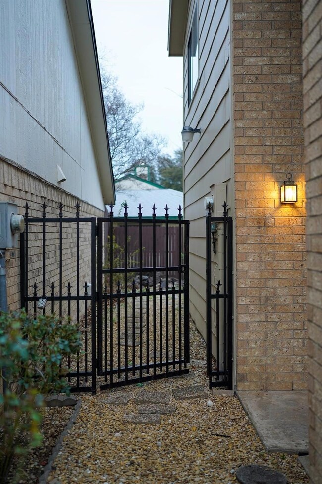 View of gate featuring fence