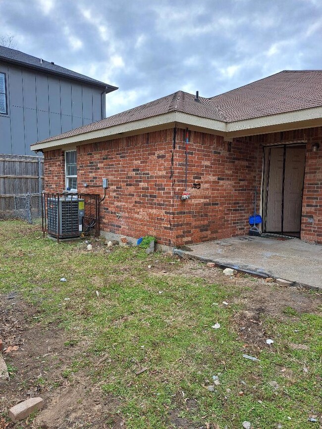 View of property exterior with cooling unit, a yar