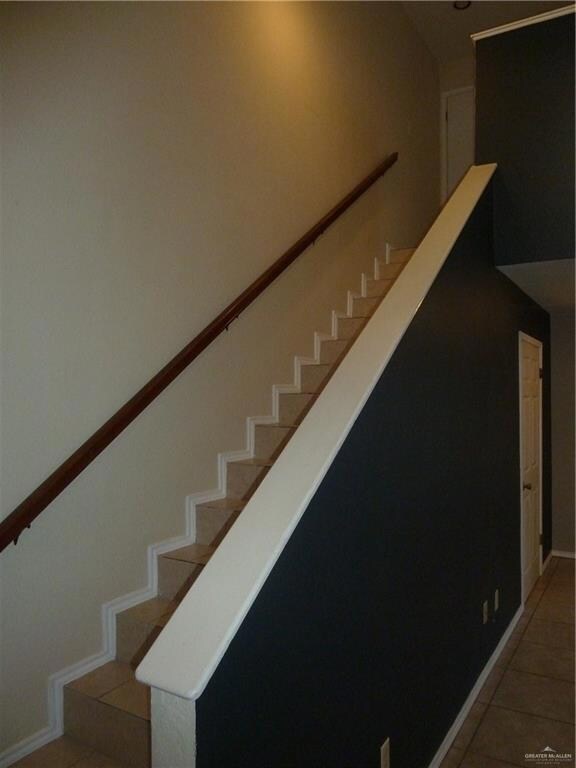 Stairs featuring tile floors