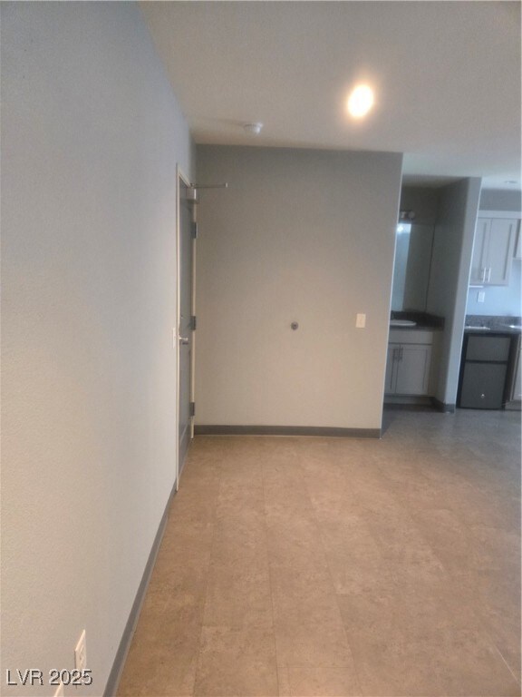 Empty room featuring baseboards