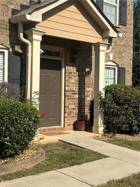 Doorway to property with brick siding