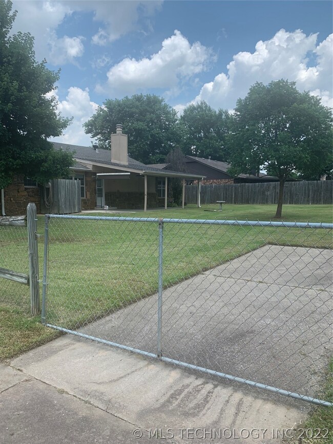 Oversize gate and parking pad in backyard.