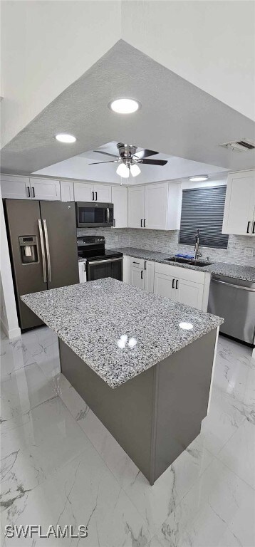 Kitchen with stainless steel appliances, white cab
