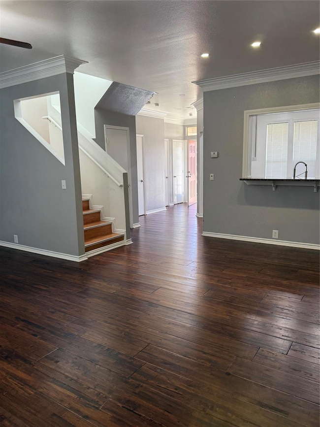 Unfurnished living room with stairway, dark wood-s