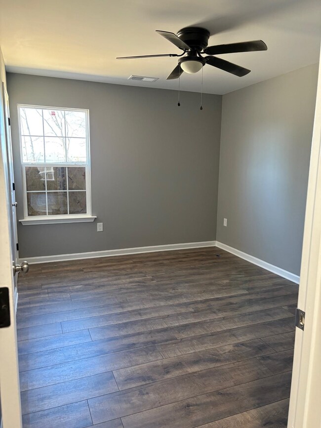 Spare room featuring dark hardwood / wood-style fl