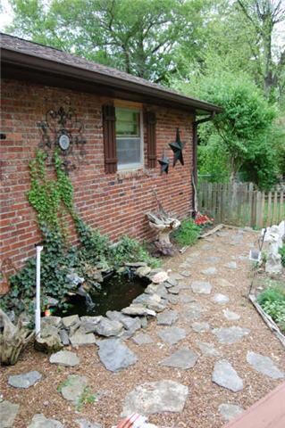 Located in the back of home, new owners will enjoy the peaceful fountain and stone path. 