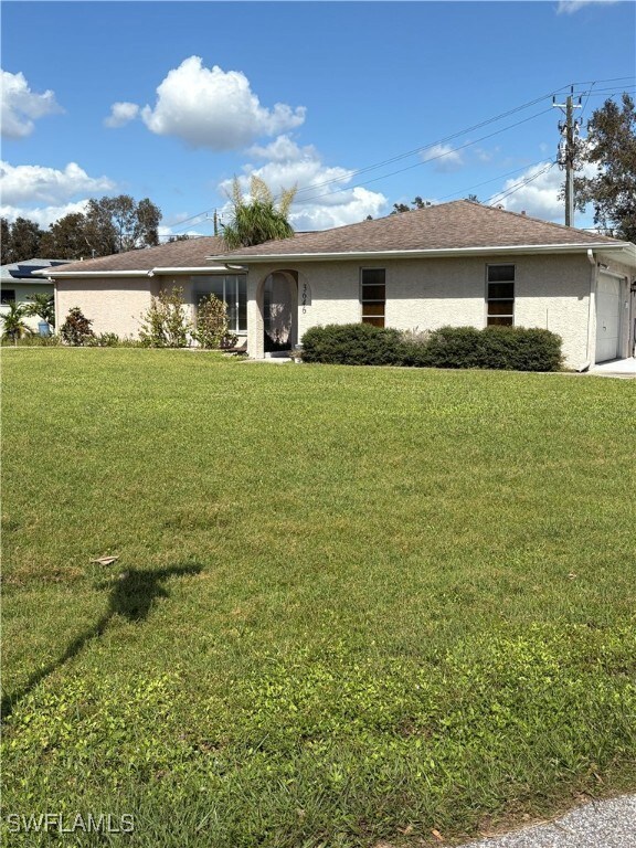 Single story home with a front lawn