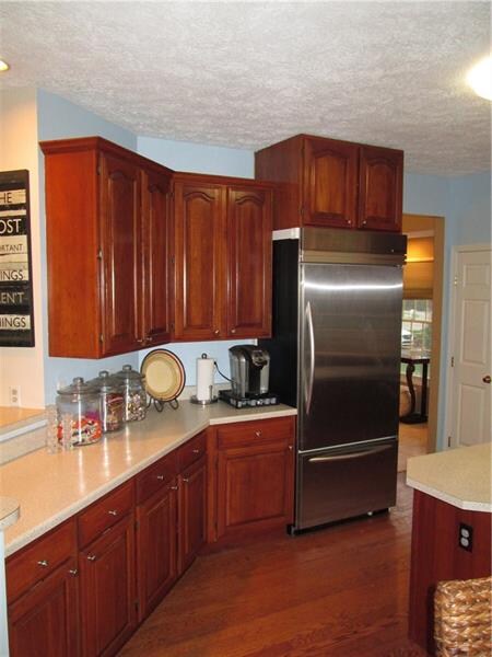 high end fridge and beautiful wood cabinets