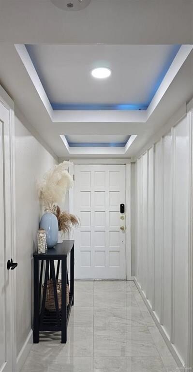 Hallway with a tray ceiling