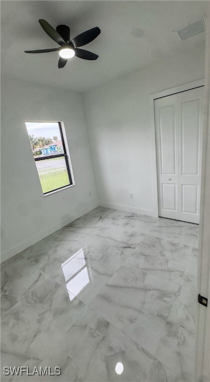 Unfurnished room with baseboards, marble look tile