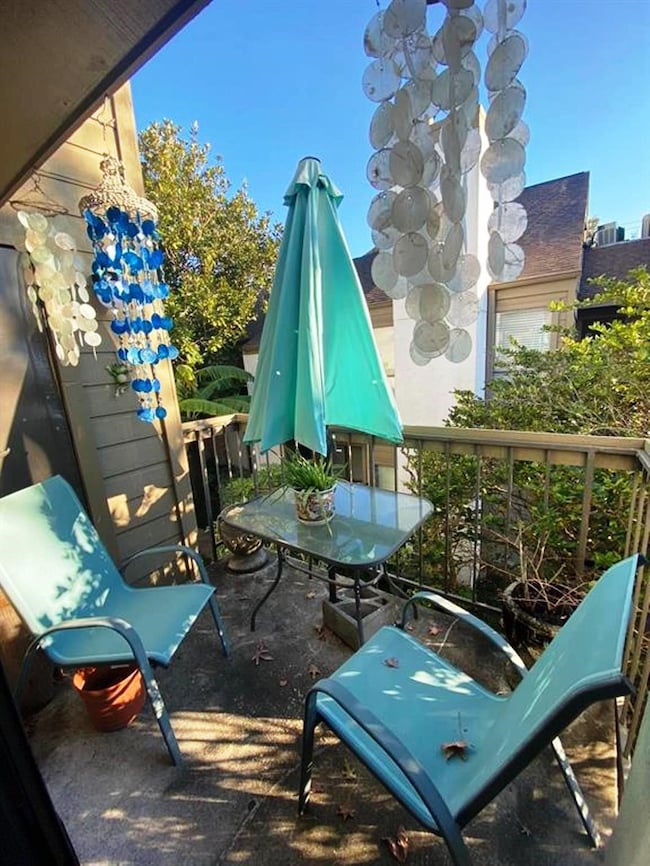 Cozy balcony with two chairs and a small glass tab