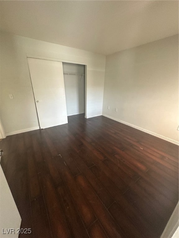 Unfurnished bedroom featuring dark wood finished f