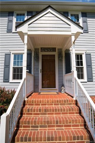 Brickk stoop, vinyl rails, custom wood door and St