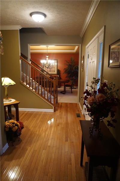 Hardwood Entry with Crown Molding and Powder Room