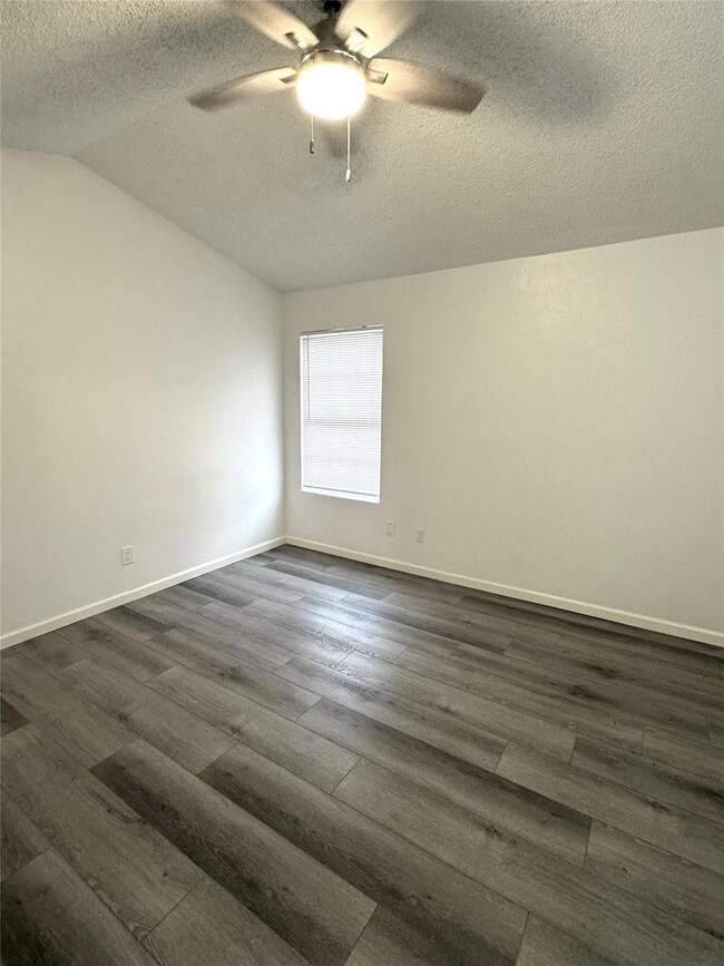 Unfurnished room with a textured ceiling, a ceili