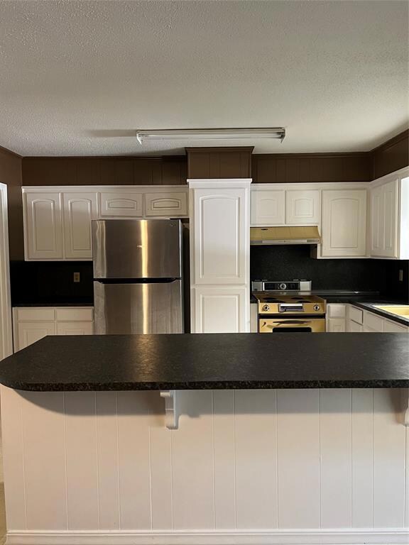 Open concept kitchen with breakfast bar.