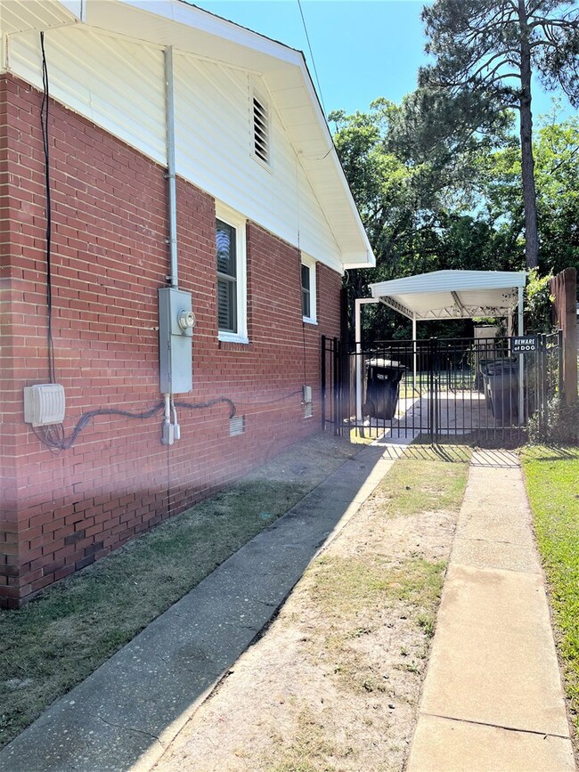 Driveway and 1 car carport with gated entry