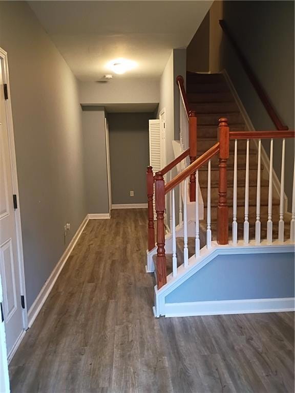 Stairs featuring wood finished floors and baseboards
