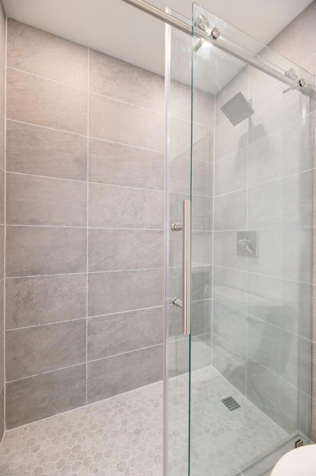 Bathroom featuring a stall shower and toilet