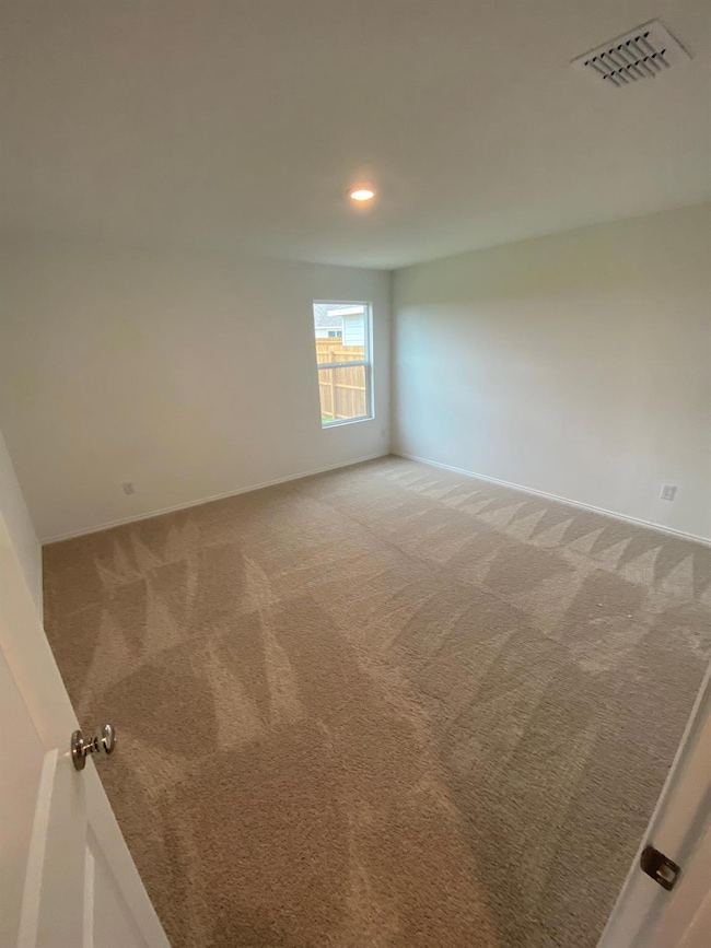 Unfurnished room with light colored carpet, visibl