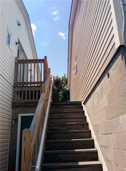 Stairs up to Units #2 & #3.  Laundry Room to left 