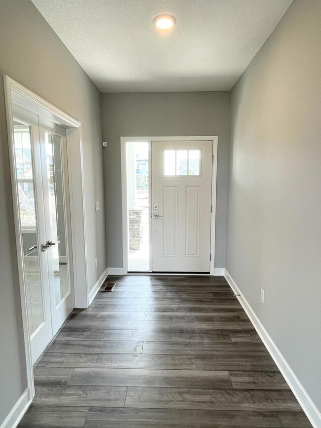 Photos is of a different, sold home. Located close to the front door makes the office so convenient for deliveries and drop by visitors.