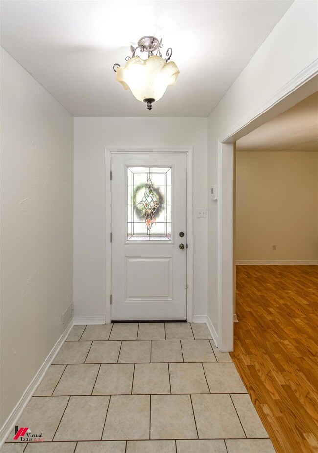 Entryway featuring Tile, Decorative door w/glass