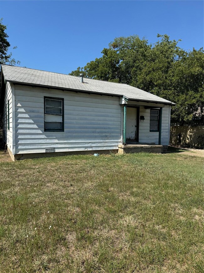 Single story home featuring a front lawn