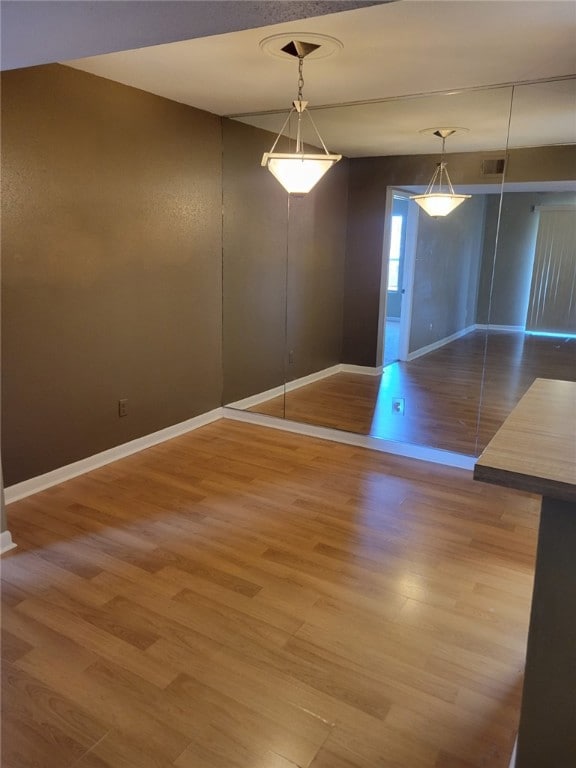 Unfurnished dining area featuring wood finished fl
