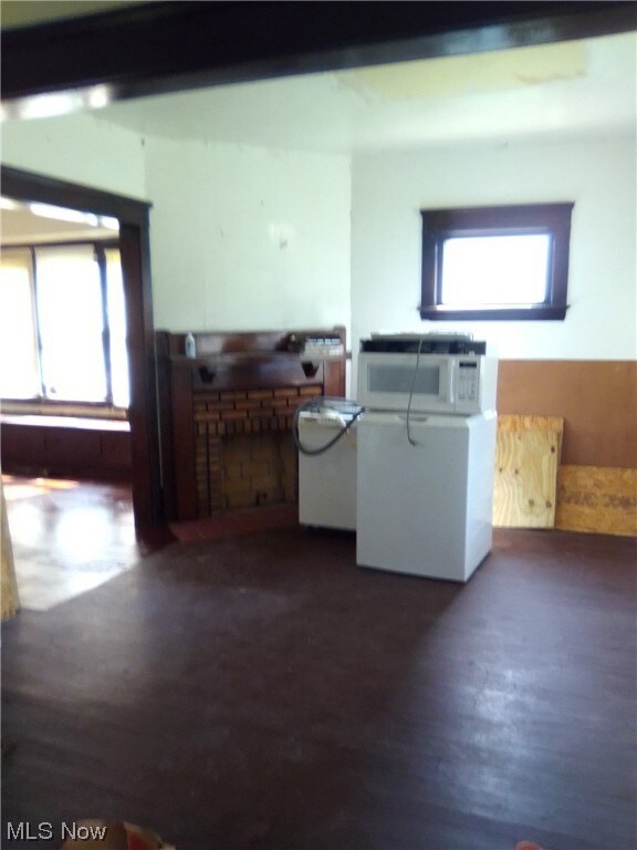 Kitchen with dark wood-type flooring and a healthy amount of sunlight