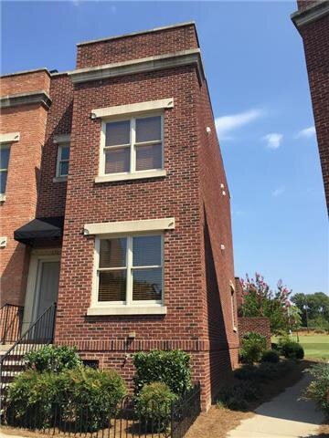 This townhome is a corner lot and features additio