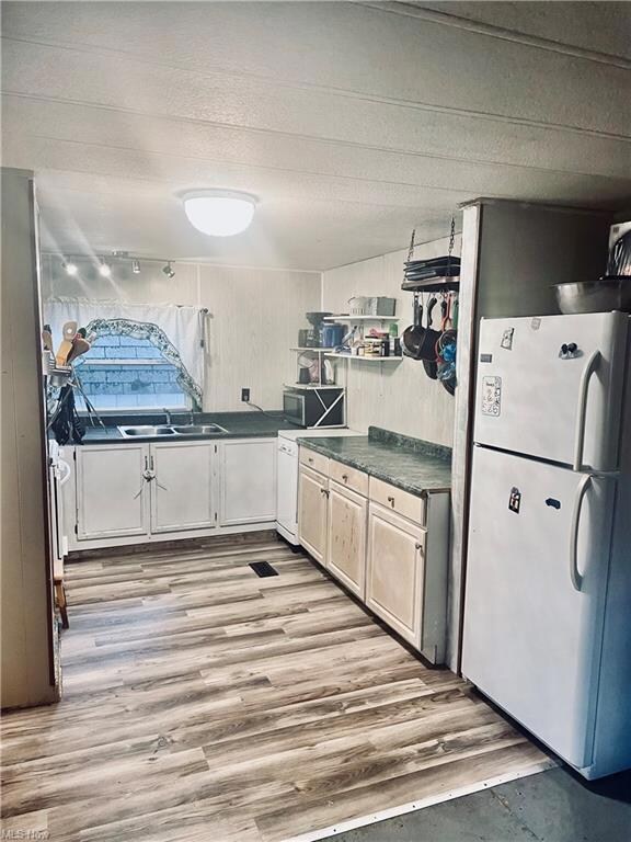 Kitchen featuring dark countertops, vinyl floors, 