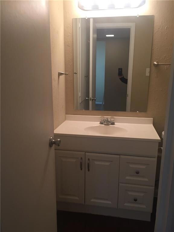 Bathroom featuring vanity and a textured wall