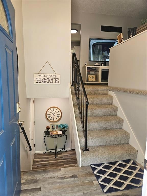 Foyer featuring hardwood / wood-style floors and a textured ceiling