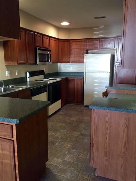 Enjoy plenty of storage in this spacious kitchen with skylights, peninsula island and planning desk.