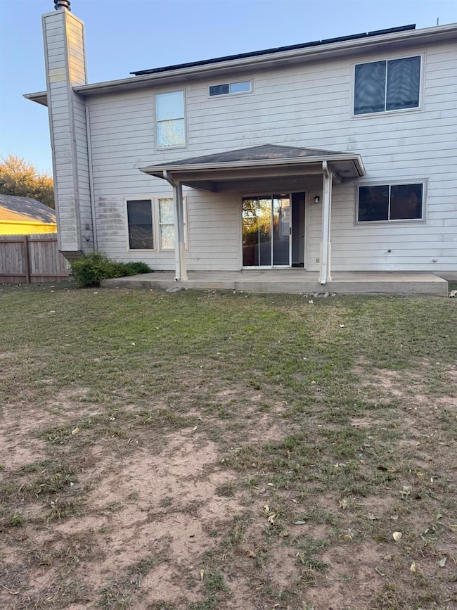 Back of property featuring a patio and a chimney