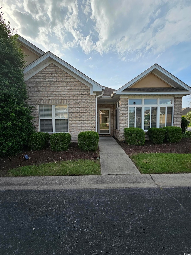 View of front of property featuring brick siding
