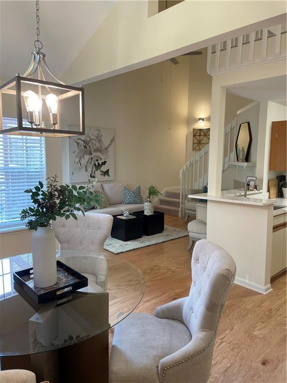 Dining area with light wood-type flooring, high va