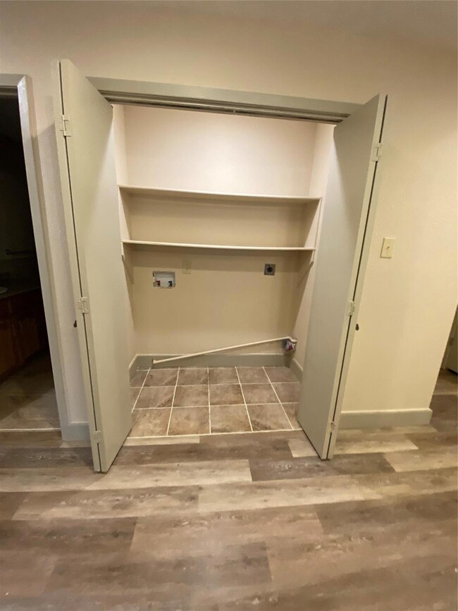 Laundry area featuring electric dryer hookup, hard