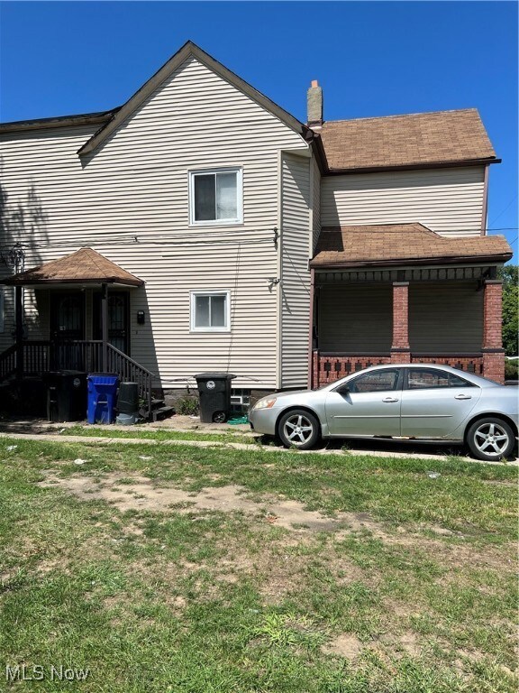 Back of house with a yard