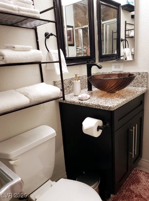 Bathroom featuring toilet and vanity