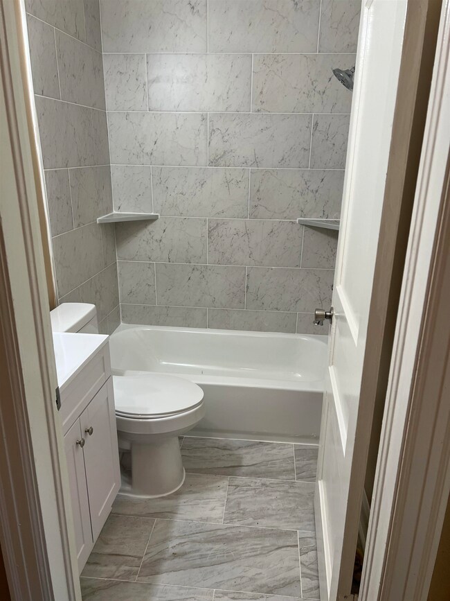 Bathroom featuring shower / bathtub combination, t